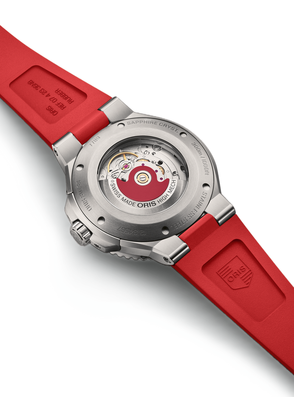 Back view of the Oris Aquis Date Relief, featuring a stainless steel case, red rubber strap, and an exposed mechanical movement.