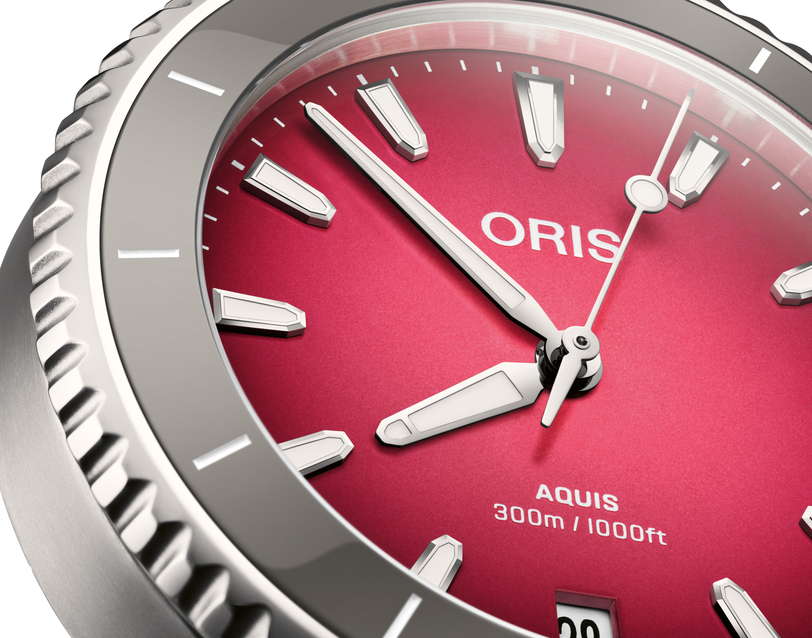 Oris Aquis Date Taste of Summer watch with a gradient sunrise pink dial and grey bezel close-up.