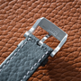 Close-up of the Chopard L.U.C XPS 1860 Officer Limited Edition For Hodinkee strap, featuring a silver “L.U.C CHOPARD” engraved buckle on textured brown leather and paired with a refined white gold case.