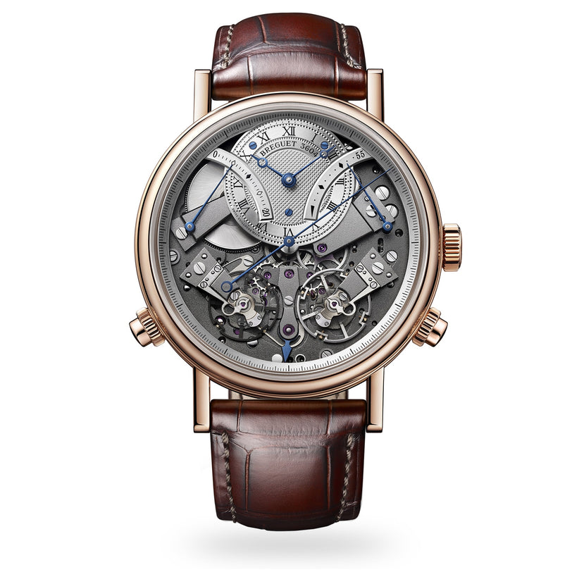 The Breguet Tradition Chronographe 7077 is a luxury mechanical watch inspired by Swiss craftsmanship, featuring an exposed intricate movement with a tourbillon, brown leather strap, Roman numerals, and gauges on a silver-toned dial.