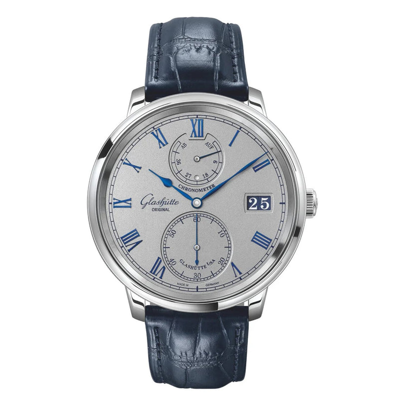 The Glashütte Original Senator Chronometer is a silver analog wristwatch with blue Roman numerals, a leather strap, subdials for seconds and power reserve, and a date window at 3 o’clock—a testament to German luxury watchmaking.