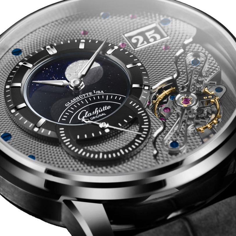 Close-up of the Glashütte Original PanoLunarInverse watch face, showcasing horological artistry with a moon phase display, skeletonized tourbillon, textured dial, and fine details from the Pano Collection.