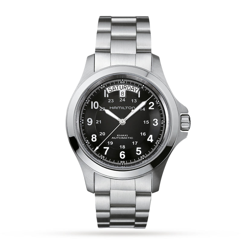 The Hamilton Khaki Field King Auto wristwatch features a black dial with military time, day and date displays, numbered hour markers, and a stainless steel bracelet, set against a white background.