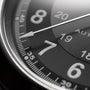 Close-up of a Hamilton Khaki Field King Auto watch face in black, displaying parts of the numbers 7, 8, and 20. A white hand points near the 37-minute mark and military time markings are visible.