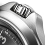 Close-up of the Hamilton Khaki Field King Auto’s stainless steel crown and bezel, showcasing brushed metal texture and a section of the dial with minute markers for legible military time reading.