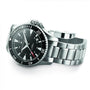 The Hamilton Khaki Navy Scuba Auto wristwatch, featuring a stainless steel case, black dial, silver hour markers, and a metal link band, is showcased against a white background, representing precision and performance.