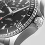 Close-up of a Hamilton Khaki Navy Scuba Auto watch, highlighting the crown, bezel, and black dial with white markers and “1000ft Automatic” text—showcasing the brands precision and performance.