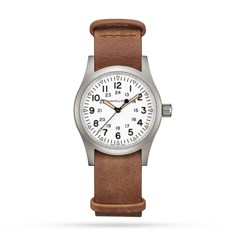 The Hamilton Khaki Field Mechanical is a classic military-inspired wristwatch with a white dial, black numerals, silver case, brown leather strap, and three hands displaying 10:10:37.