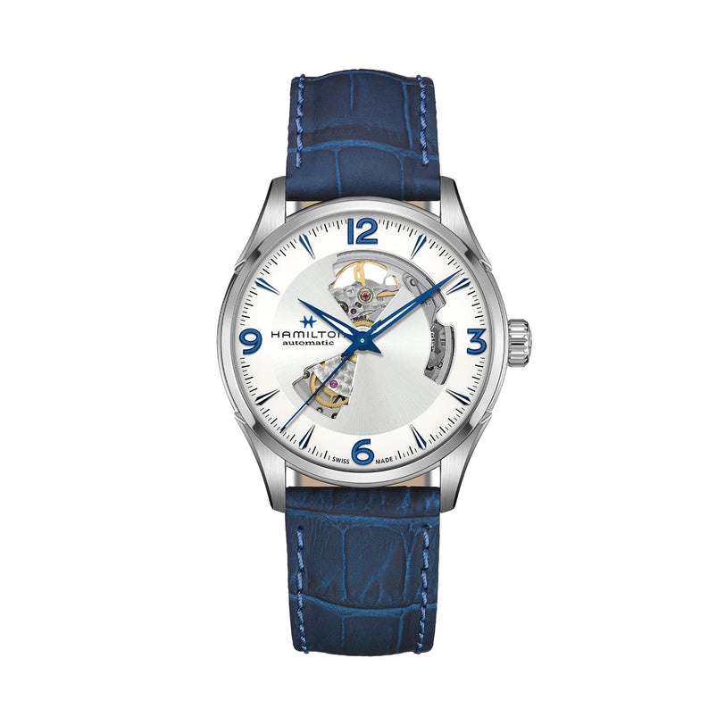 The Hamilton Jazzmaster Open Heart wristwatch features a Swiss-made automatic movement, a partial skeleton silver dial with blue numerals, and a textured blue leather strap, shown against a white background.