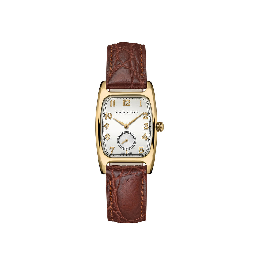 The Hamilton American Classic Boulton Quartz wristwatch features a gold rectangular case, white dial with gold hour markers, a small seconds subdial, and a brown leather strap for timeless elegance and Swiss precision.