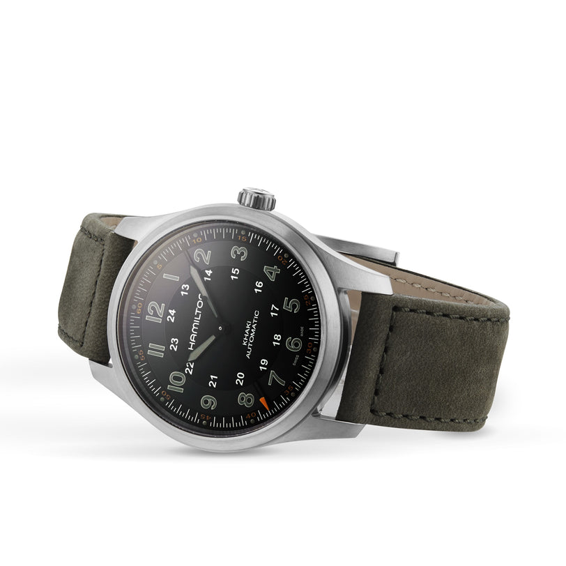 The Hamilton Khaki Field Titanium Auto, featuring a black dial, green canvas strap, and white Arabic numerals, is displayed at an angle on a white background, highlighting its classic army-inspired design.