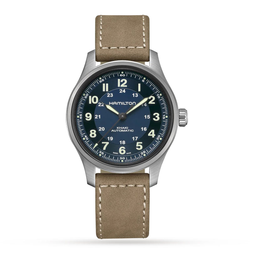 The Hamilton Khaki Field Titanium Auto features a blue dial with white numerals and a tan leather strap, combining modern materials with classic military-inspired design, shown on a white background.