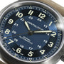Close-up of the Hamilton Khaki Field Titanium Auto watch, featuring a blue dial, beige numerals, and luminous hands set at 10:10:37—a versatile timepiece made for adventure.