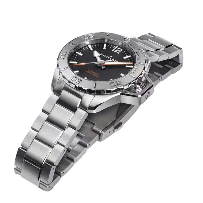 The Hamilton Khaki Navy Frogman Auto is a stainless steel automatic watch with a black dial, silver hour markers, and a metal link band, shown at an angle on a white background and featuring remarkable water resistance.