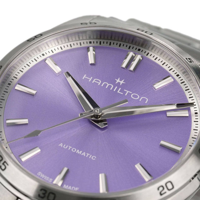 Close-up of the Hamilton Jazzmaster Performer Auto watch featuring a purple dial, stainless steel markers and hands, with Automatic displayed above 6 o’clock.
