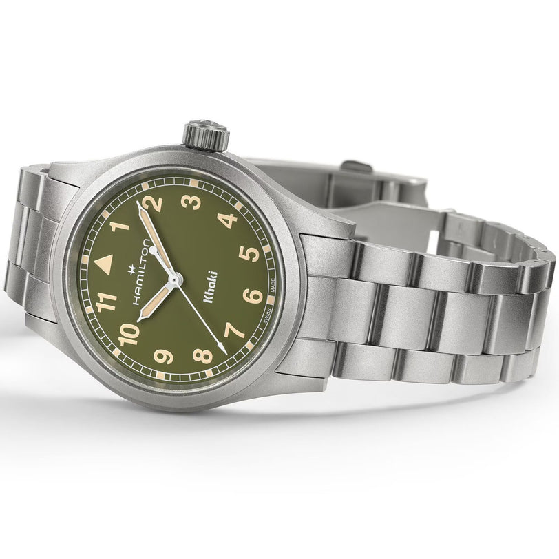 The Hamilton Khaki Field Quartz 38mm features a stainless steel case, olive green dial with Arabic numerals, and comes on a metal bracelet.
