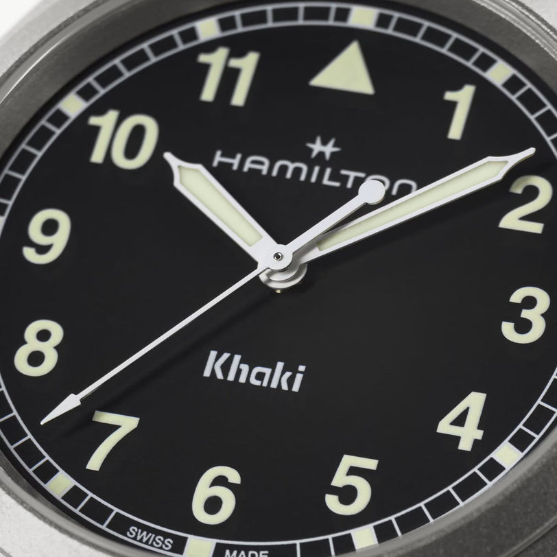 Close-up of a Hamilton Khaki Field Quartz 38mm watch face at 10:10:36, featuring luminous hands and numbers.