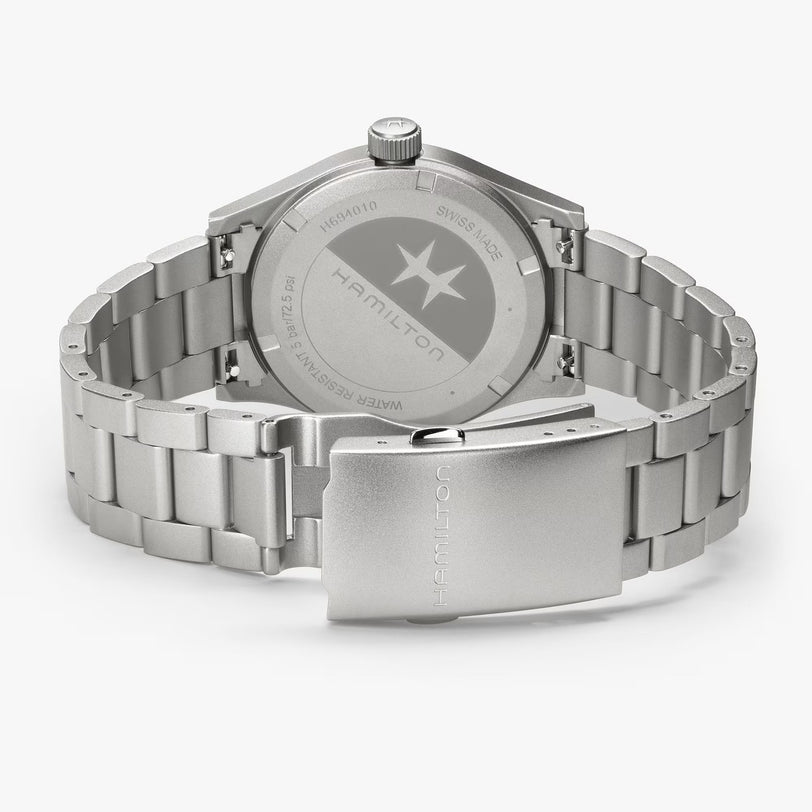 The Hamilton Khaki Field Quartz 38mm watch in stainless steel is displayed on a white background, highlighting its engraved case back and clasp.