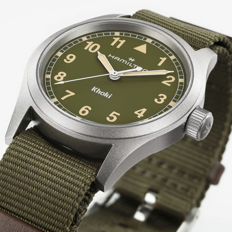 Close-up of the Hamilton Khaki Field Quartz 38mm watch featuring an olive green dial and fabric strap.