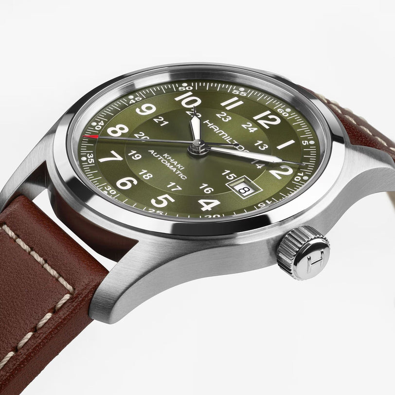 Close-up of the Hamilton Khaki Field Auto 42mm wristwatch featuring an olive green dial and a brown leather strap.