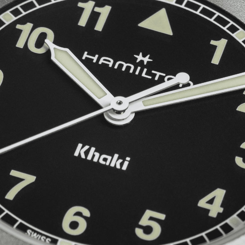 Close-up of the Hamilton Khaki Field Quartz 33mm, featuring luminous hands and bold Arabic numerals on a black dial—built for adventure. Time displayed: 10:08:37.