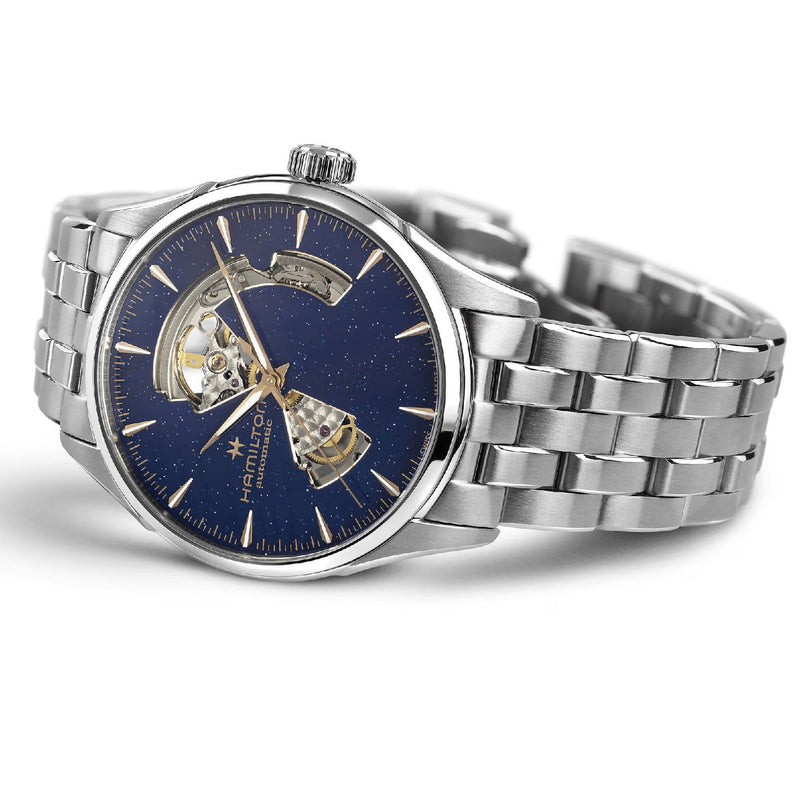 The Hamilton Jazzmaster Open Heart Auto 42mm features a stainless steel case, blue speckled dial with visible automatic movement, silver bracelet, and is ideal for fans of elegant dress watches.