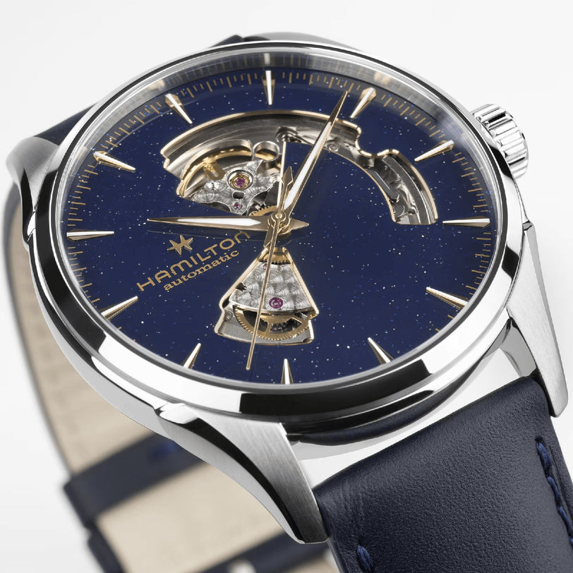 A close-up of the Hamilton Jazzmaster Open Heart Auto 42mm, featuring a blue starry dial, stainless steel case, partial skeleton design, and blue leather strap—an exquisite dress watch choice.