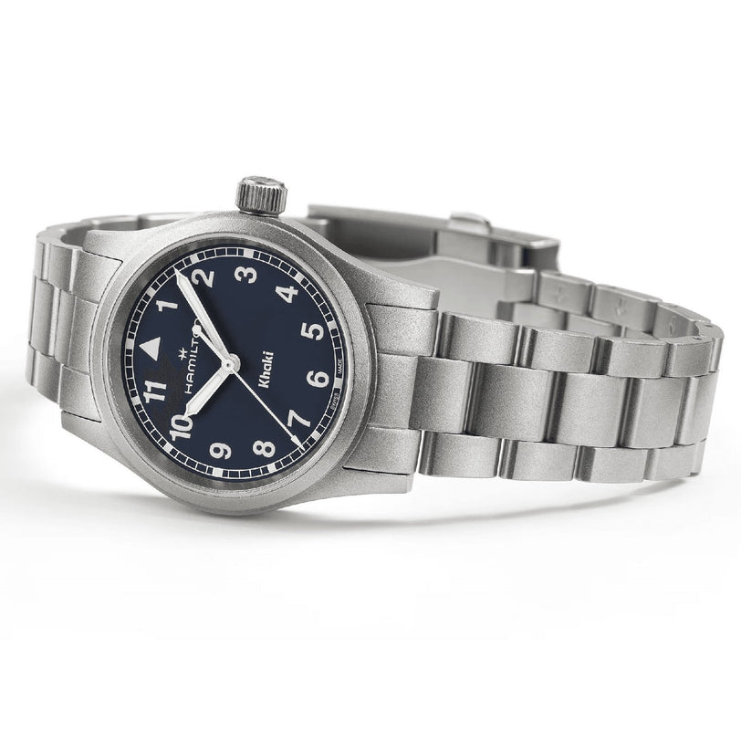 The Hamilton Khaki Field Quartz 33mm is a stainless steel adventure watch with a black dial, white numerals, and metal bracelet, shown displaying the time at 10:09.