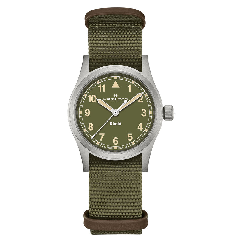 The Hamilton Khaki Field Quartz 33mm wristwatch features an olive green dial with white numerals and an olive fabric strap, reflecting its military heritage, set against a plain white background.
