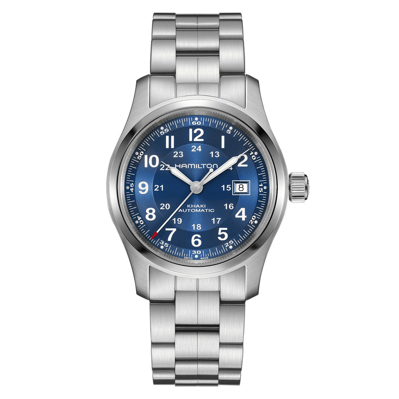 The Hamilton Khaki Field Auto 42mm is a stainless steel watch with a blue dial, white numerals, H-10 automatic movement, date at 3 o’clock, and metal bracelet. Hamilton’s military heritage appears below 12 o’clock.