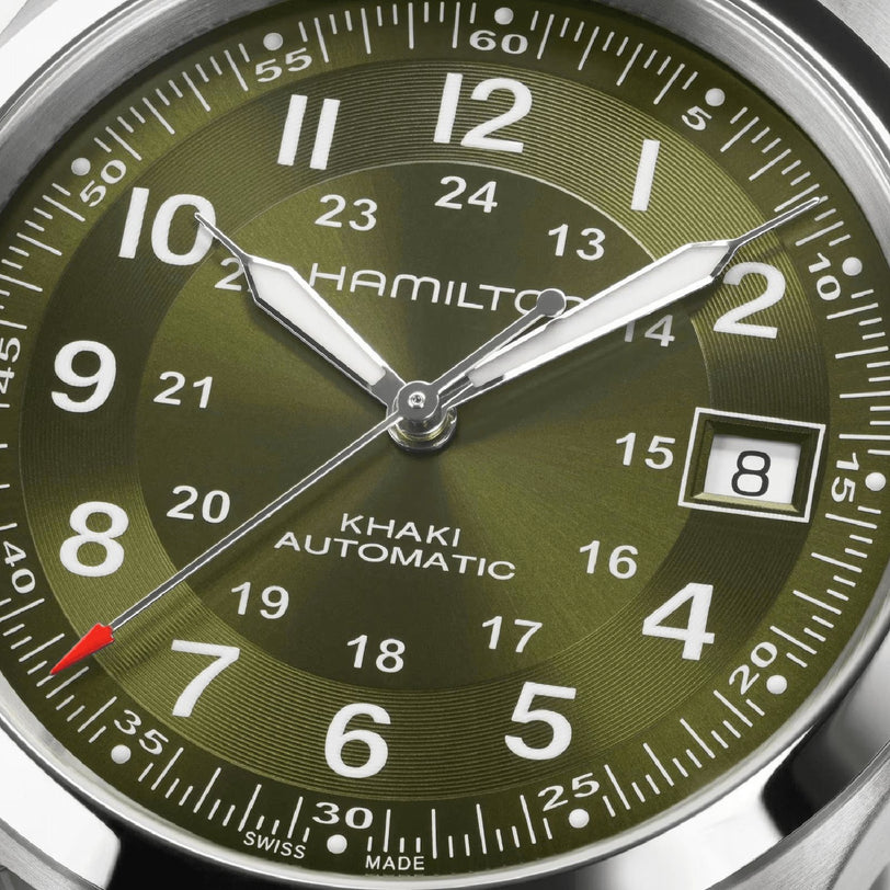 Close-up of the Hamilton Khaki Field Auto 38mm watch in green, displaying 8:07:36 with a date window at 8—showcasing its automatic movement and iconic military-inspired design.