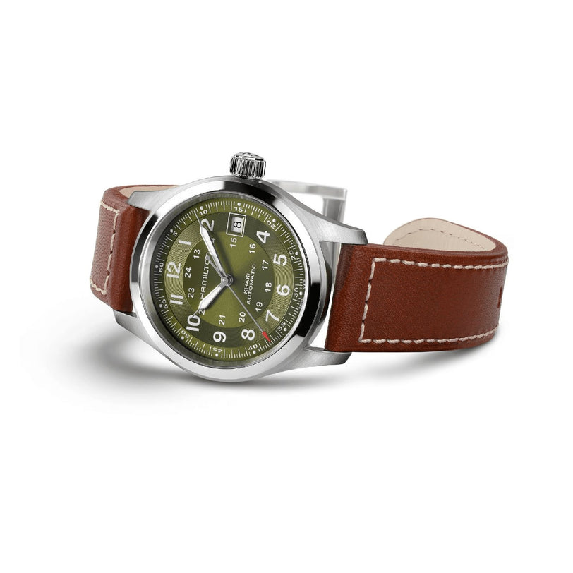 The Hamilton Khaki Field Auto 38mm is a silver wristwatch with a military-inspired design, featuring an olive green face, white numerals, and a brown leather strap—shown angled on a white background.