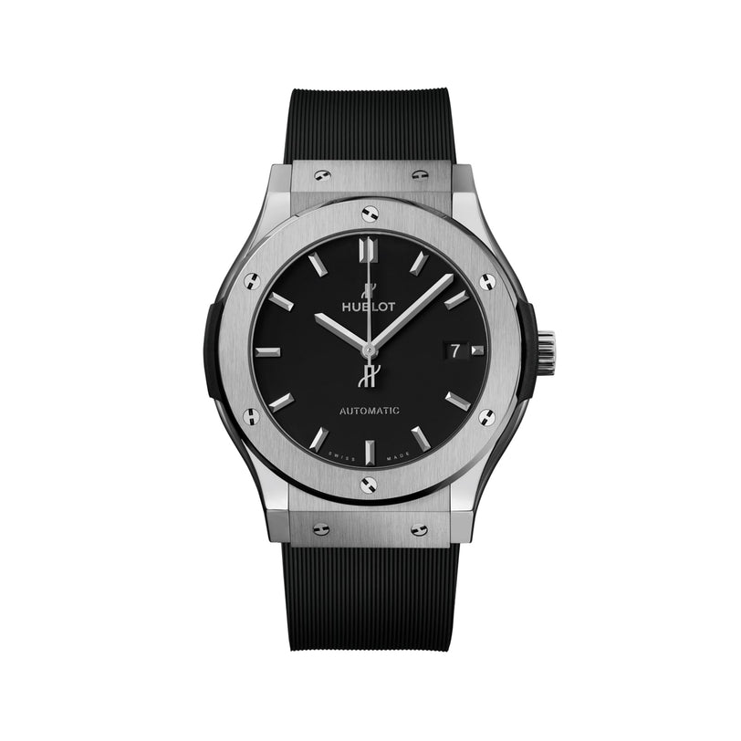 The Hublot Classic Fusion Titanium features a black dial, silver hour markers, titanium case, date at 3 oclock, and a black rubber strap, all set against a white background.