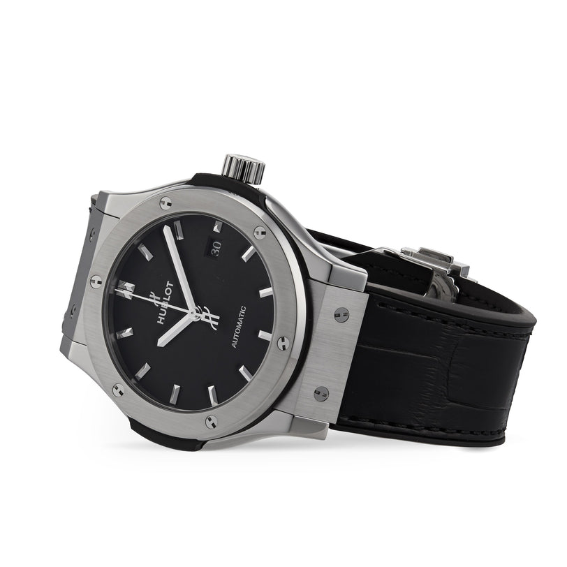 A Hublot Classic Fusion Titanium wristwatch with a black dial, silver hour markers, and a black leather strap with automatic movement, shown at an angle on a white background.