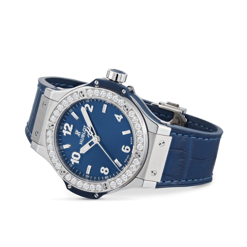The Hublot Big Bang Steel Blue Diamonds wristwatch features a blue sunray dial, silver case, stainless steel bezel set with 36 diamonds, and a blue leather strap, displayed at an angle on a white background.