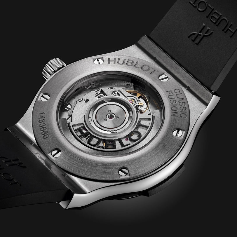Close-up of the Hublot Classic Fusion Titanium watch’s back, featuring a see-through case back that reveals the self-winding movement, with visible branding and serial numbers.