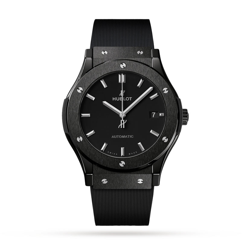 A Hublot Classic Fusion Black Magic automatic wristwatch with a black ceramic case, black dial, silver hour markers, date display, and black ribbed strap is photographed on a white background.