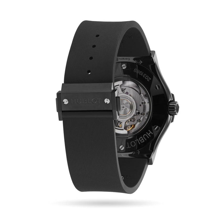 Back view of the Hublot Classic Fusion Black Magic with a black ceramic case, visible self-winding movement, and a black rubber strap displaying the Hublot logo.