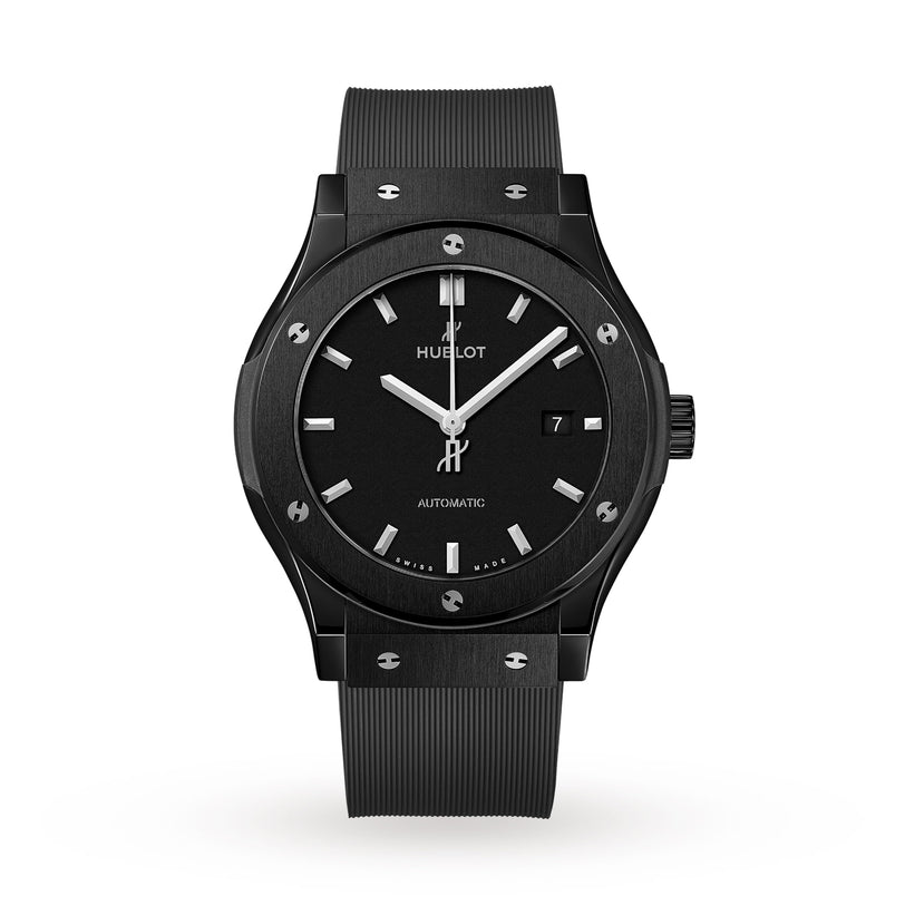 The Hublot Classic Fusion Black Magic features a black high-tech ceramic case, black dial with silver markers, date display at 3 o’clock, and a black rubber strap, shown on a white background.