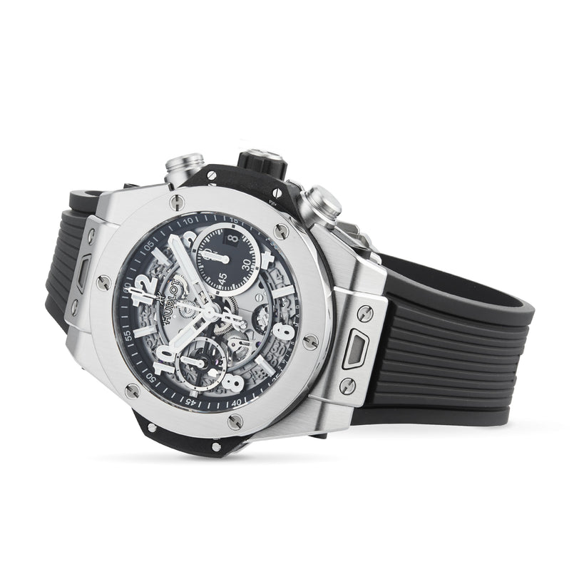 The Hublot Big Bang Unico Titanium is a silver and black chronograph watch with a skeleton dial, rubber strap, and visible gears showcasing the UNICO flyback movement, shown against a white background.