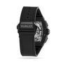 A Hublot Spirit Of Big Bang Black Magic wristwatch with a black ceramic case and rubber strap is shown from the back, featuring the brand name and part of its intricate skeleton dial mechanism.