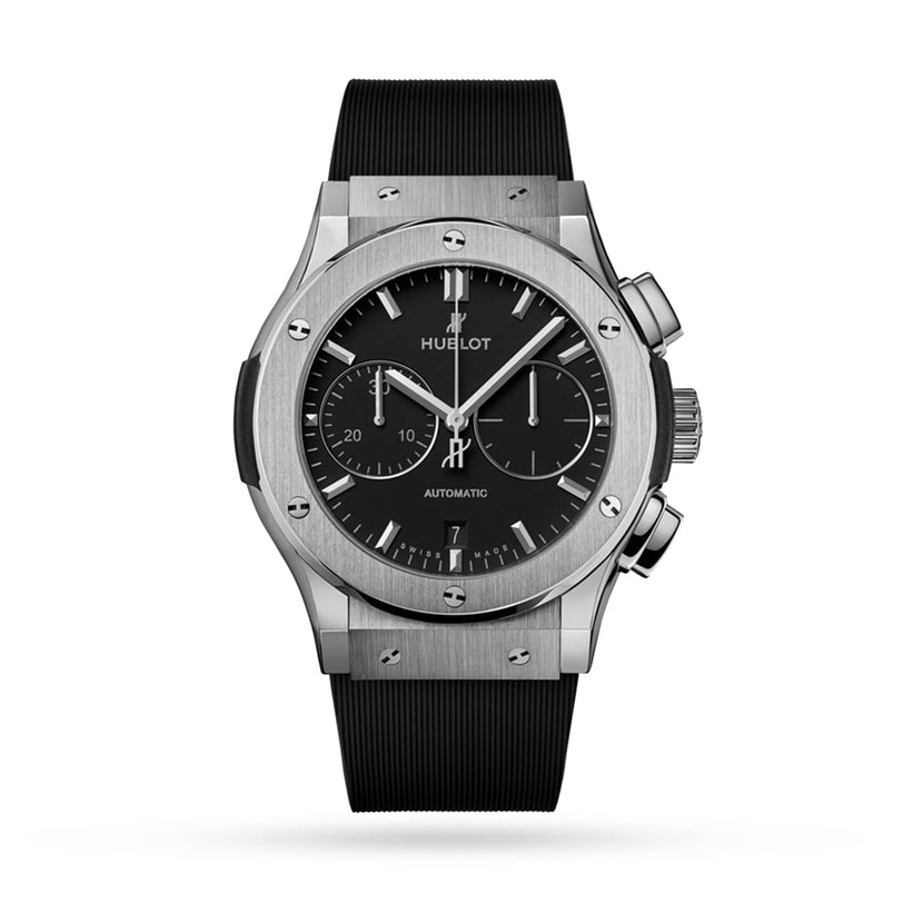 The Hublot Classic Fusion Chronograph Titanium features a silver titanium case, black dial with three subdials and date at 6 o’clock, plus a black textured rubber strap.