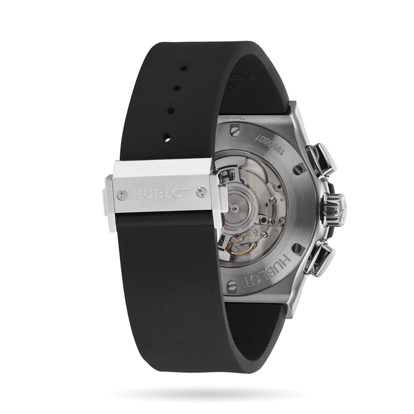 Back view of the Hublot Classic Fusion Chronograph Titanium, showcasing its visible chronograph movement, black rubber strap, and a stainless steel clasp engraved with Hublot in a sleek titanium case.