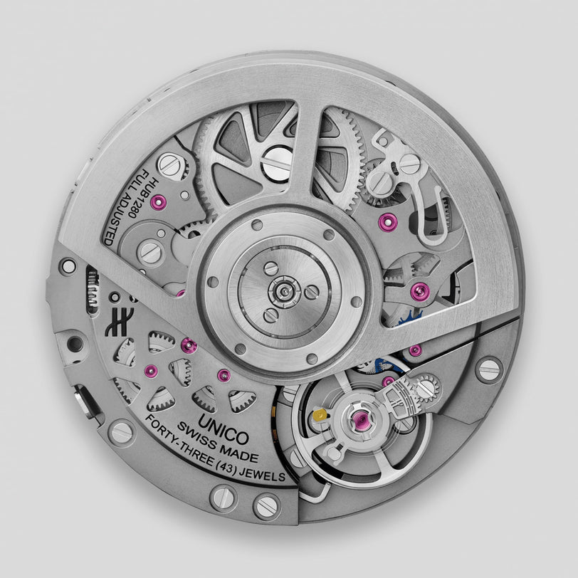 Close-up of the Hublot Square Bang Unico Titanium Ceramic, showcasing its Swiss-made UNICO movement with visible gears, engraved UNICO and FORTY-THREE (43) JEWELS, all beneath a sapphire crystal.