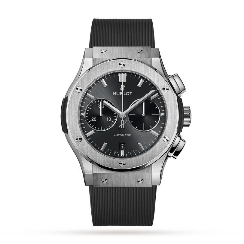The Hublot Classic Fusion Racing Grey Chronograph Titanium features a titanium case, racing grey dial with three subdials, date window at 6 o’clock, and a black rubber strap.