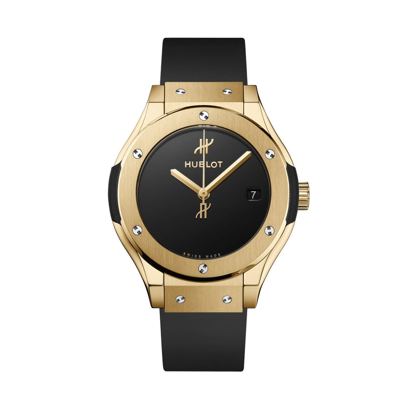 The Hublot Classic Fusion Original Yellow Gold wristwatch features a black face, black band, minimalist hour markers, date at 3 o’clock, and a self-winding movement, shown on a white background.