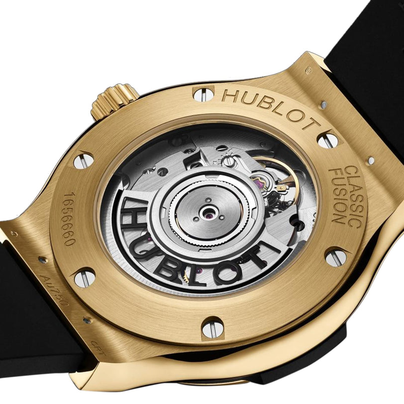 Close-up of the Hublot Classic Fusion Original Yellow Gold watch back, displaying its gold case, engraved Hublot branding, and visible self-winding calibre movement.