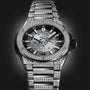 The Hublot Big Bang Integrated Time Only Titanium Pavé is a luxury watch with a titanium case and metal band set with diamonds, plus a partially skeletonized dial and visible gears, inspired by the Big Bang Integrated Time collection.