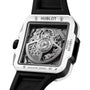A close-up of the Hublot Square Bang Unico White Ceramic wristwatch, featuring a white ceramic case, black strap, and visible skeletonized Unico movement.