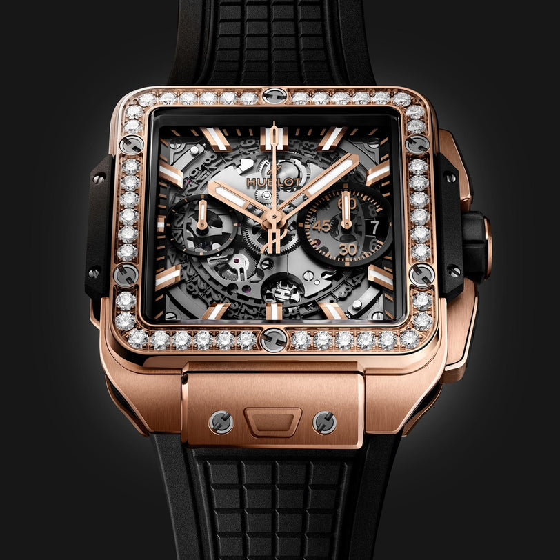 Hublots Square Bang Unico King Gold Diamonds features a King Gold case, diamond bezel, skeleton dial with Unico movement and two subdials, plus a black textured rubber strap—all showcased against a dark background.